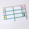 Calendar-style notepad with colorful geometric designs on a white background