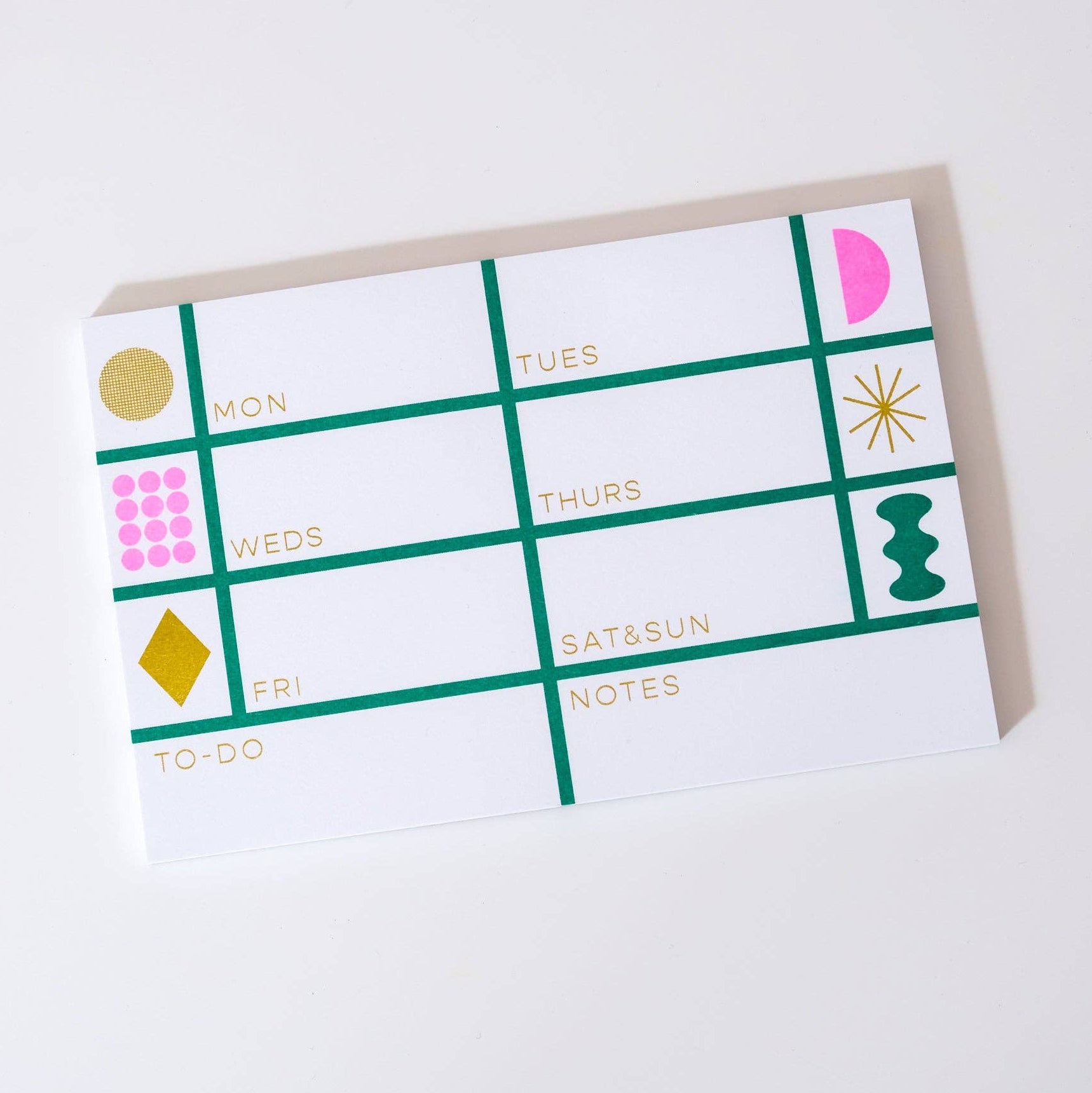 Calendar-style notepad with colorful geometric designs on a white background