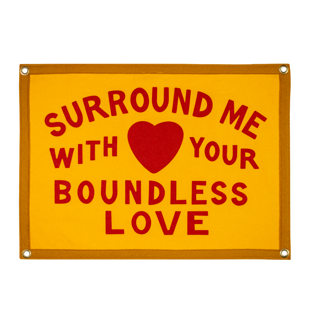 Yellow sign with red text and heart symbol on a white background