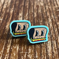 Two cartoon-style silkscreen squeegee cartoon earrings on a wooden surface with 'Rapscallion' branding.